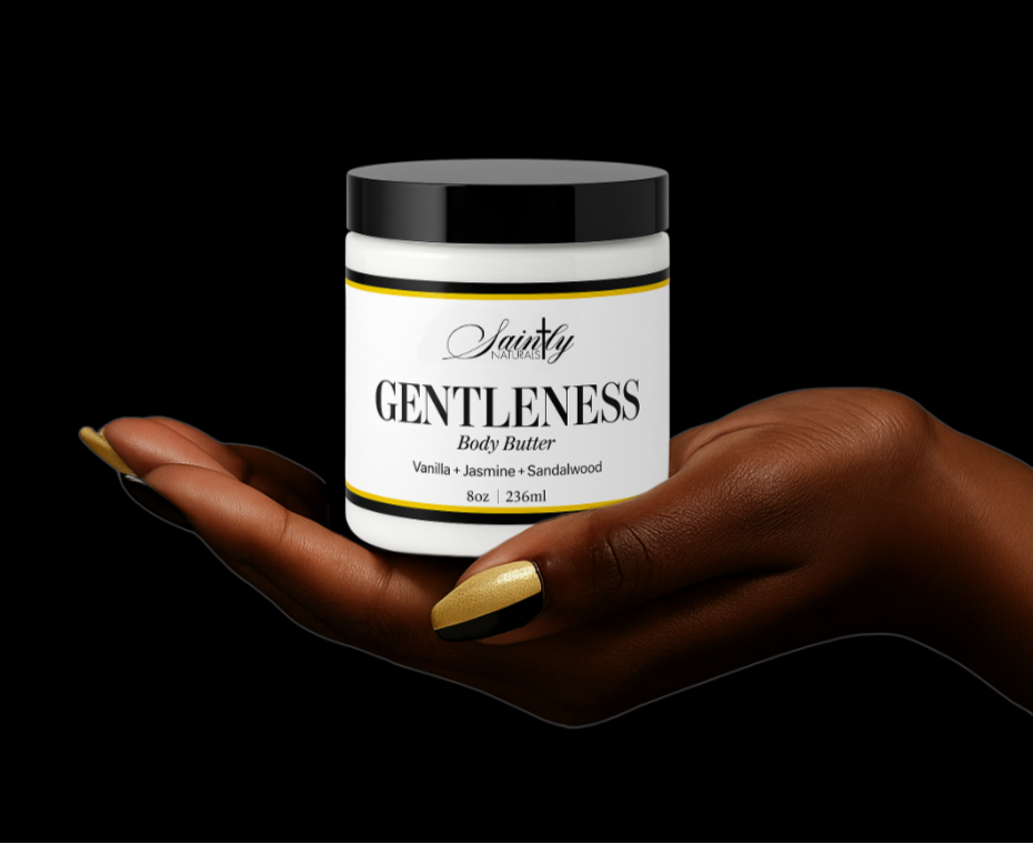 Jar of 'Gentleness' body butter held in a hand against a black background